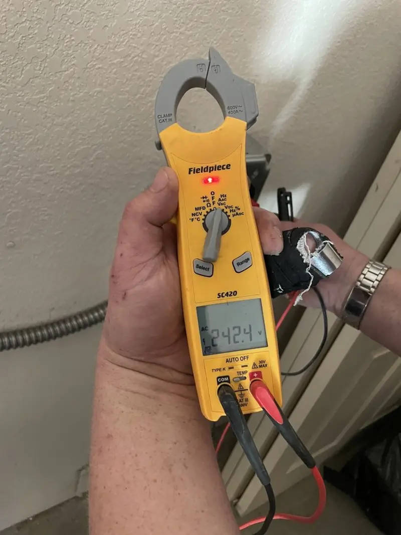 Voltage testing with clamp meter during Outlet Installation in Lake Sarasota